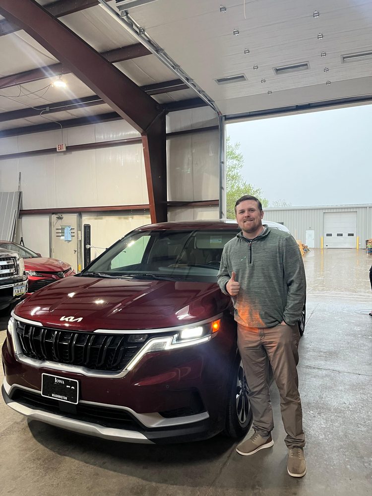 Noah Catron with his restored Kia Carnival